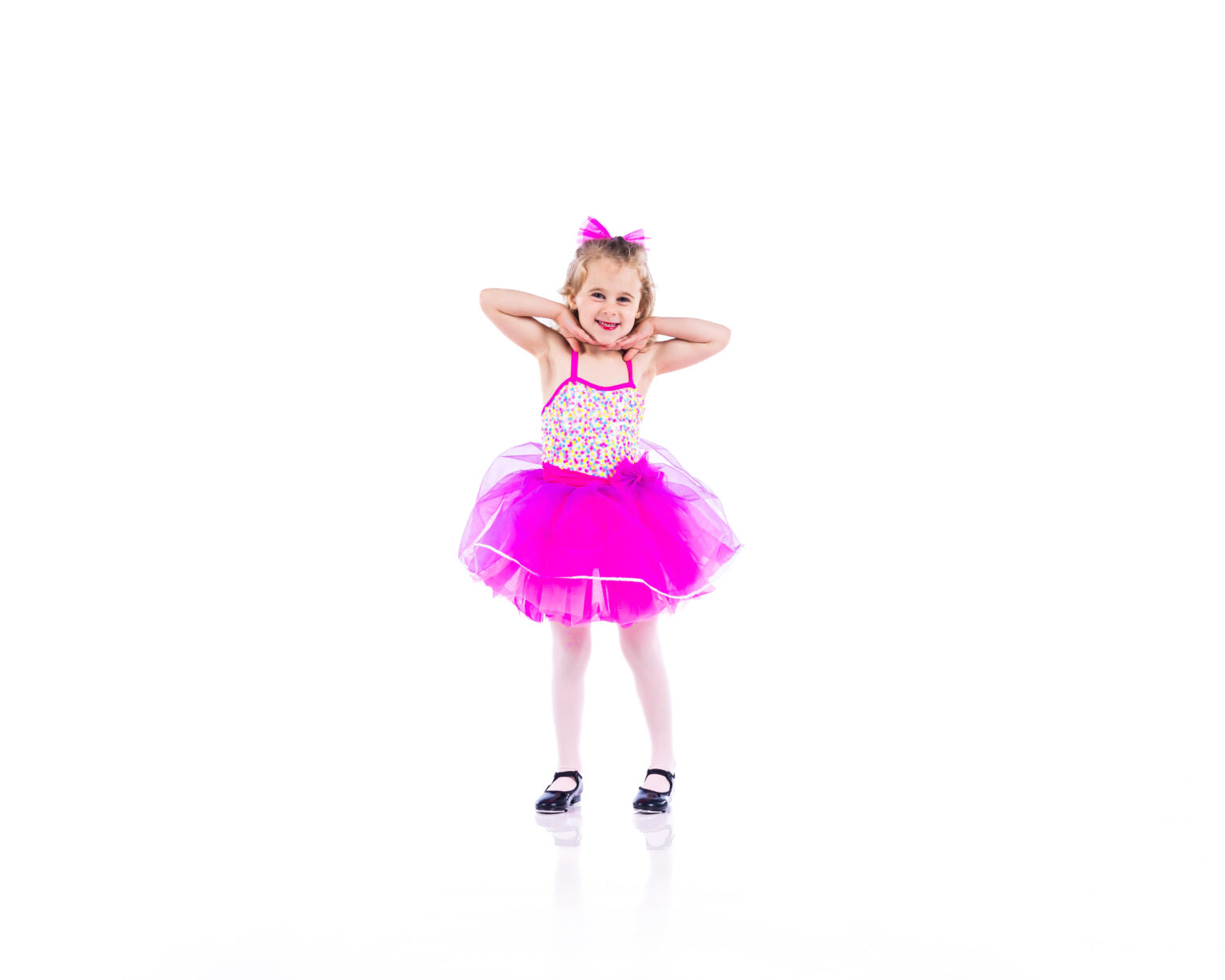 Smiling preschool dancer in a pink tutu