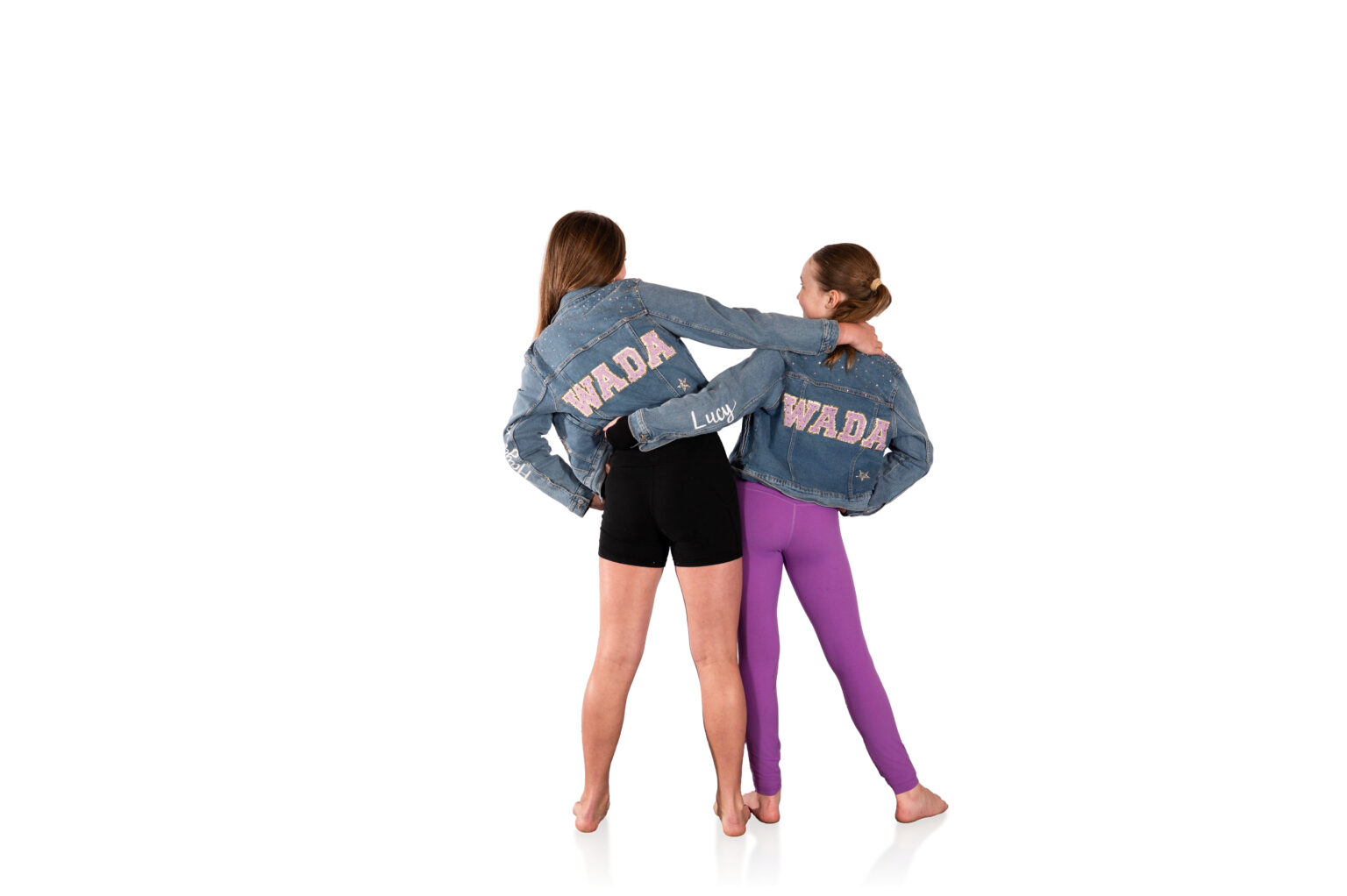 Two dancers arm in arm in matching WADA jackets
